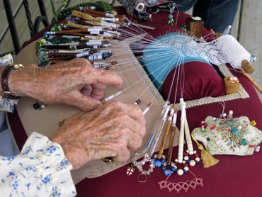 This beautiful photo of a woman occupied with lacemaking ... the old way ... tatting lace on a pillow (hence the name "pillow lace") was taken by Robert Linder of Springfield, Missouri.